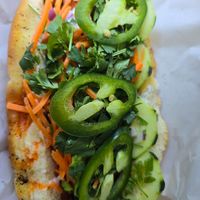 vegan banh mi dog with chili crisp, veganaise, carrots, cilantro & jalapeños at Drop City in Trinidad