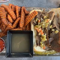 Vegan Italian beef handheld with sweet potato fries  at Alter Brewing + Kitchen in Oak Brook