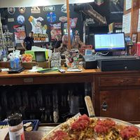 In the mirror chowing down  at Caliente Pizza & Drafthouse - Liberty Ave in Pittsburgh