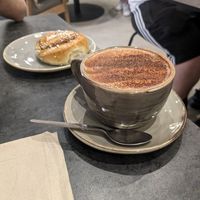 O boy hot chocolate with oat milk and cinnamon bun (v) at Scandinavian Kitchen in London