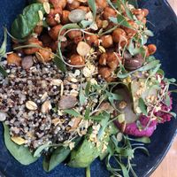Flower salad with chickpeas, beetroot hummus, quinoa, avocado and spinach.   at Amélia Foz in Porto