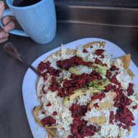 Chilaquiles con chorizo y café americano at Distopía Coffee Zone in Mexico City