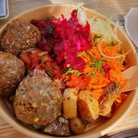 Falafel with cabbage, carrots, hot tomato dish, beetroot and potatoes with tahini sauce at OUNE Falafel in Brussels