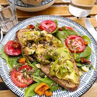 Avocado toast that just had salmon taken off the top at Mälis in Biarritz