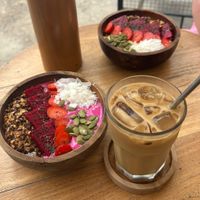 Dragonfruit smoothie bowl and mango smoothie bowl asked for without honey.  Oat milk iced latte.   at Tropical Brew in Penida Island