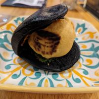 Batata vada in a charcoal bun  at Bombay Talkies in Kuala Lumpur