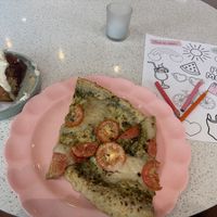 2 pesto pizza slices with rewarmed day old cinnamon bun. 16$  at Petunia's Pies and Pastries in Portland