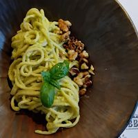Green pasta (spaghetti dipped in a bit of sauce with a few walnuts) at Fabbrica in Pula