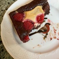 Raspberry brownie (on a cute plate). at Korzenie Kuchnia Roślinna  in Szczecin