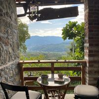 Terrace seating  at The House in the Village in Pellumbas