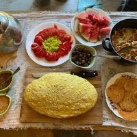 All vegan breakfast. Homegrown tomatoes and figs, homemade hummus and fresh baked bread  at The House in the Village in Pellumbas