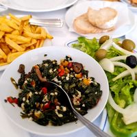 The vegan dish: homemade chips with skin, sautéed veggies and salad. at O Pelourinho in Alijo
