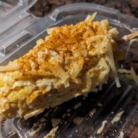 vegan elote—corn on the cob smothered in butter, sour cream, and shredded cheese, topped with tajín at La Rumba Restaurant Latino in Asheville