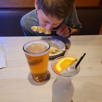 Husband trying Elote Corn at La Rumba Restaurant Latino in Asheville