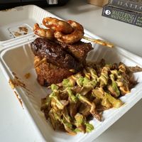 Vegan shrimp, steak, mofongo under with yellow rice w/green olives. Fries on the side!  at House of Mofos in Orlando