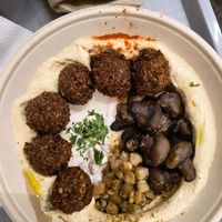 Complete hummus bowl with mushroom, falafel and chickpeas at Hummusbar in Budapest