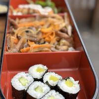 Bento box comprising fried tofu, noodle dish, Californian rolls  at Aji Sushi in Hove
