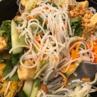 Rice noodles, veggies, herbs, fried tofu and a cut up egg roll  at Bobun Moi in Paris
