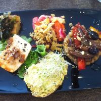 Seaweed/tomato cake, quinoa risotto with roasted veg, homemade turmeric "cheese" on delicious fresh bread, marinated tofu at Carmen Ragosta in Paris