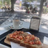 Oatmilk cappuccino & tomato, basil, olive oil toast  at Metro da Trindade in Porto
