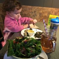 Della taking apart some yummy grape leaves  at iCreate Cafe in Pottstown