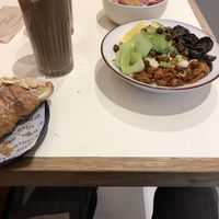 Hippie bowl, almond croissant and raw choclate smoothie  at Oatis in London