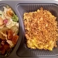 Vegan "Kasnockerl" with roasted onions and salad at Cafe Harvest in Vienna