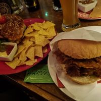 Beyond burger with tortillas and seitan "döner" pieces with tzatziki  and onion in a bun at Cafe Harvest in Vienna