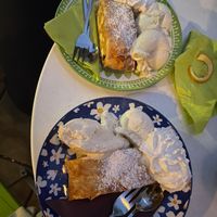 Apple strudel with vanilla ice cream and whipping cream  at Cafe Harvest in Vienna