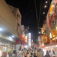 Allley to restaurant leads to an arcade type area with shops and there are stalls with shaved ice and fruit coated in candy for desert   at Shinsekai Paprika Shokudo Vegan in Osaka
