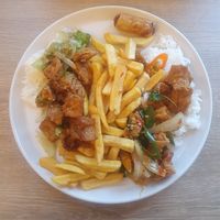 (Left) Tofu stir fry with garlic and black pepper. (Right) Tofu stir fry with holy basil and Thai chillies. Jasmine rice and chips. Spring rolls. at Chilli Banana in Wilmslow