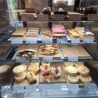 Some vegan food in the cabinet - Snickers slice, carrot cake, sausage roll, pie at The Falls Cafe in Omanawa