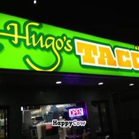 Sign is lit up at night, making it an easy find at Hugo's Tacos - Atwater Village in Los Angeles