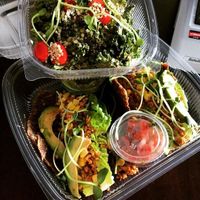 My Kale salad and Vegan, raw tacos on onion wrap to go! at The Green Eatery in Milton