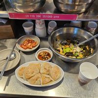The bibimbap without egg, kimchi, and steamed kimchi dumplings are vegan. at Kwangjang Market in Seoul
