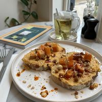 Smashed pumpkin on bread with chili oil and crunchy chickpeas.  at June  in Tilburg