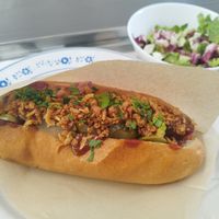 Vegan hot dog with buckwheat bread, mixed salad at Grashka Deli in Ljubljana