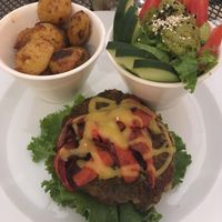 Lentil burger with vegan cheese, potatoes and salad  at La Senda Restaurante in Playa Del Carmen