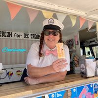 The owner holding up a vegan orange creamsicle pop 🍊   at Cowabunga Ice Cream Truck in Valley Springs