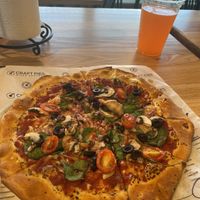 Pizza dough with vegan cheese and veggies  at Craft Pies Pizza Company in Denison
