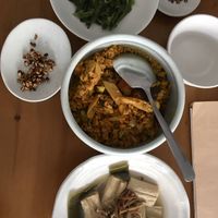 Top to bottom: seaweed salad, turmeric mushroom rice, yuba and kelp cooked in broth. Puffed oats were served as an amuse-bouche.  at Gu Li Zi Ran Feng Wei in Tainan