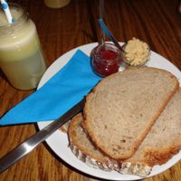 Vegan breakfast: fresh juice, bread with jam and hummus at DopHert in Amsterdam