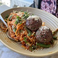 Impossible Pasta:  Palmini noodles in Pomadoro sauce with impossible meatballs, green beans, asparagus, vegan gouda cheese, vegan parmesan, micro basil.  at Malibu Farm in San Diego