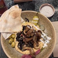 Spicy hummus with oyster mushroom shawarma, grilled aubergine and soy yogurt lime toppingg  at The Hummus Connection  in Nuremberg