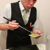 The chef preparing fresh wasabi at sushi bar fish 4 u in Tokyo