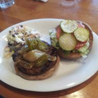 Burger with pickles and coleslaw at Veggie Grill in Laguna Niguel