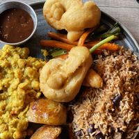 Fried dumplings, jerk sauce, veg, rice and peas, potatoes, chickpea curry  at Jamrock in Leeds