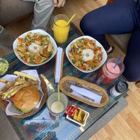 On the right- vegetable curry, on the left- vegan chickpea burger, all drinks are vegan (juice/ smoothie w/ soy milk)  at La Casa de Bamboo in Huacachina