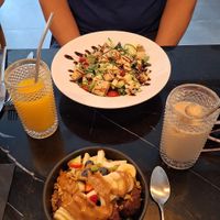 Açai bowl and grilled tofu salad. Decaf iced coffee with oat milk & fresh orange juice at Euphoria Coffee & Brunch in Cascais