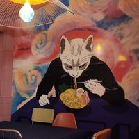 Cat eating ramen at Miau Street Food in Denia